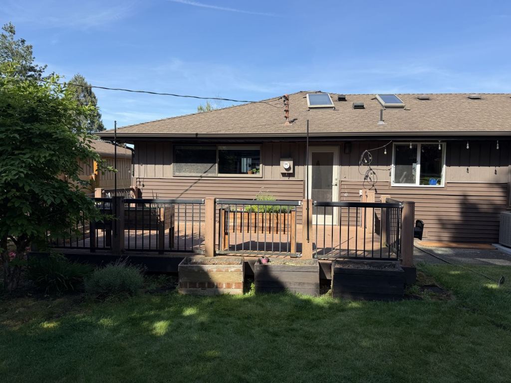 The original deck photographed straight on, running the full width of the rear elevation.
