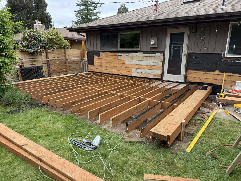 Completed joist layout with blocking, protective tape applied along the top of the framing.
