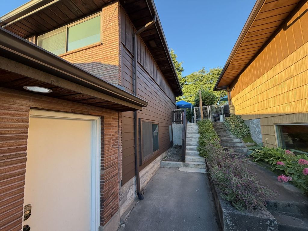 The same side elevation finished in new brown fiber cement lap siding.