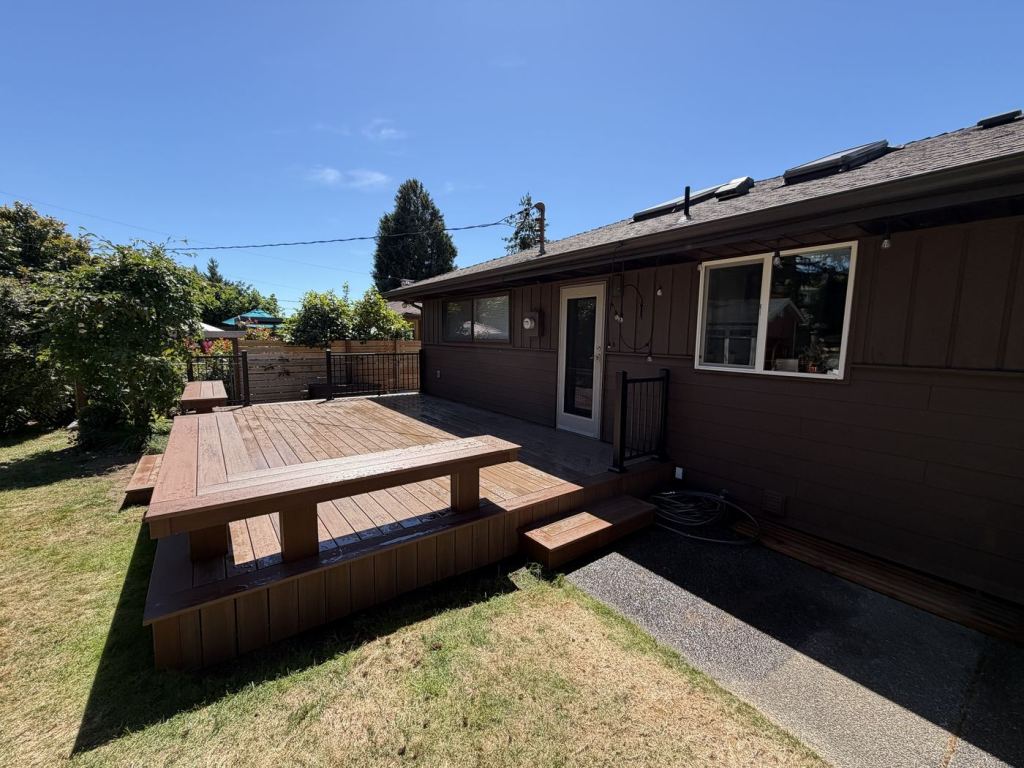 The completed deck from the right, showing the step blocks at each end and the bench.