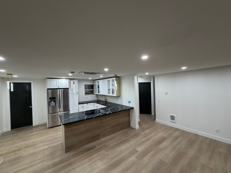 The open-concept Burien kitchen and living room, viewed from the far end