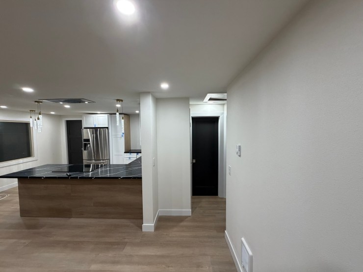 View from the hallway into the open Burien kitchen and living area