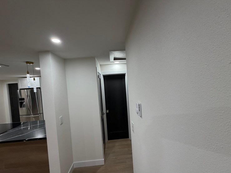 Hallway leading from the Burien kitchen past the new fireplace wall