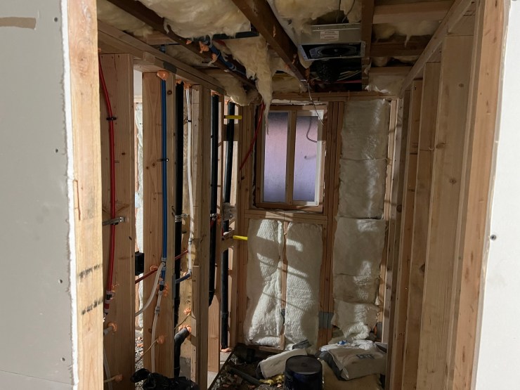 Open wall framing and insulation during the primary bathroom remodel