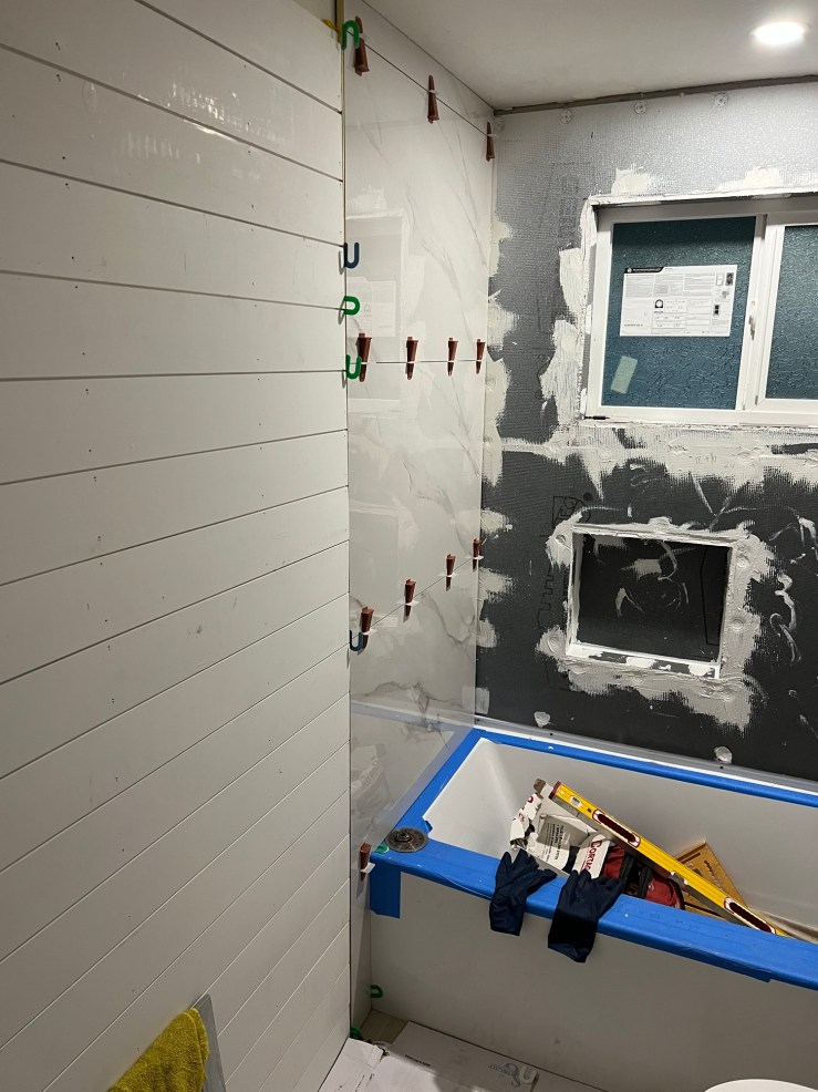 Waterproofed shower corner with the tub during the rough-in stage of the second bathroom remodel