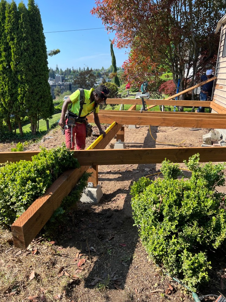 Measuring and cutting a beam while framing the West Seattle view deck