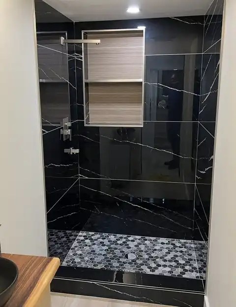 The same Tacoma shower finished in black marble-look tile
