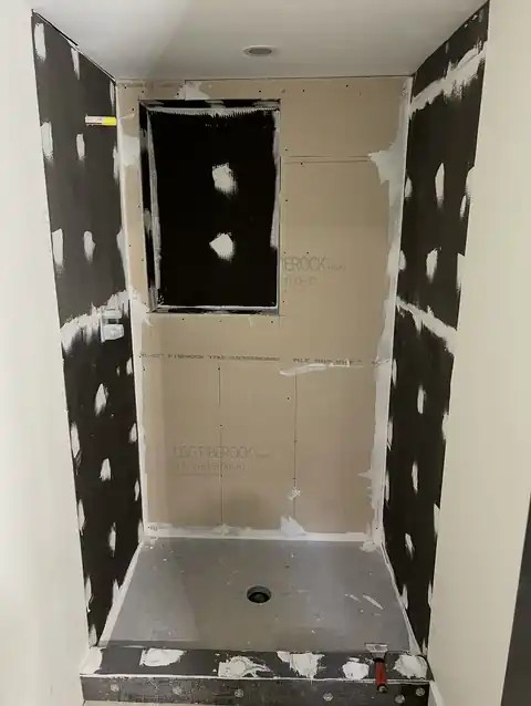 Tacoma shower walls in tile backer board and waterproofing, before tile