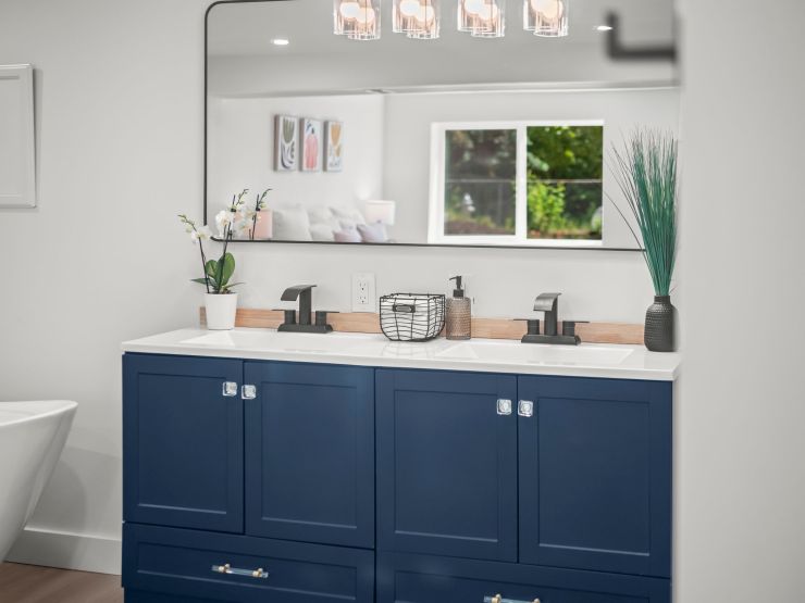 Navy double vanity with matte black fixtures in the primary bathroom