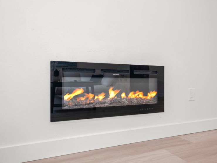 A second linear electric fireplace from the same Tacoma project, mounted on a plain white wall