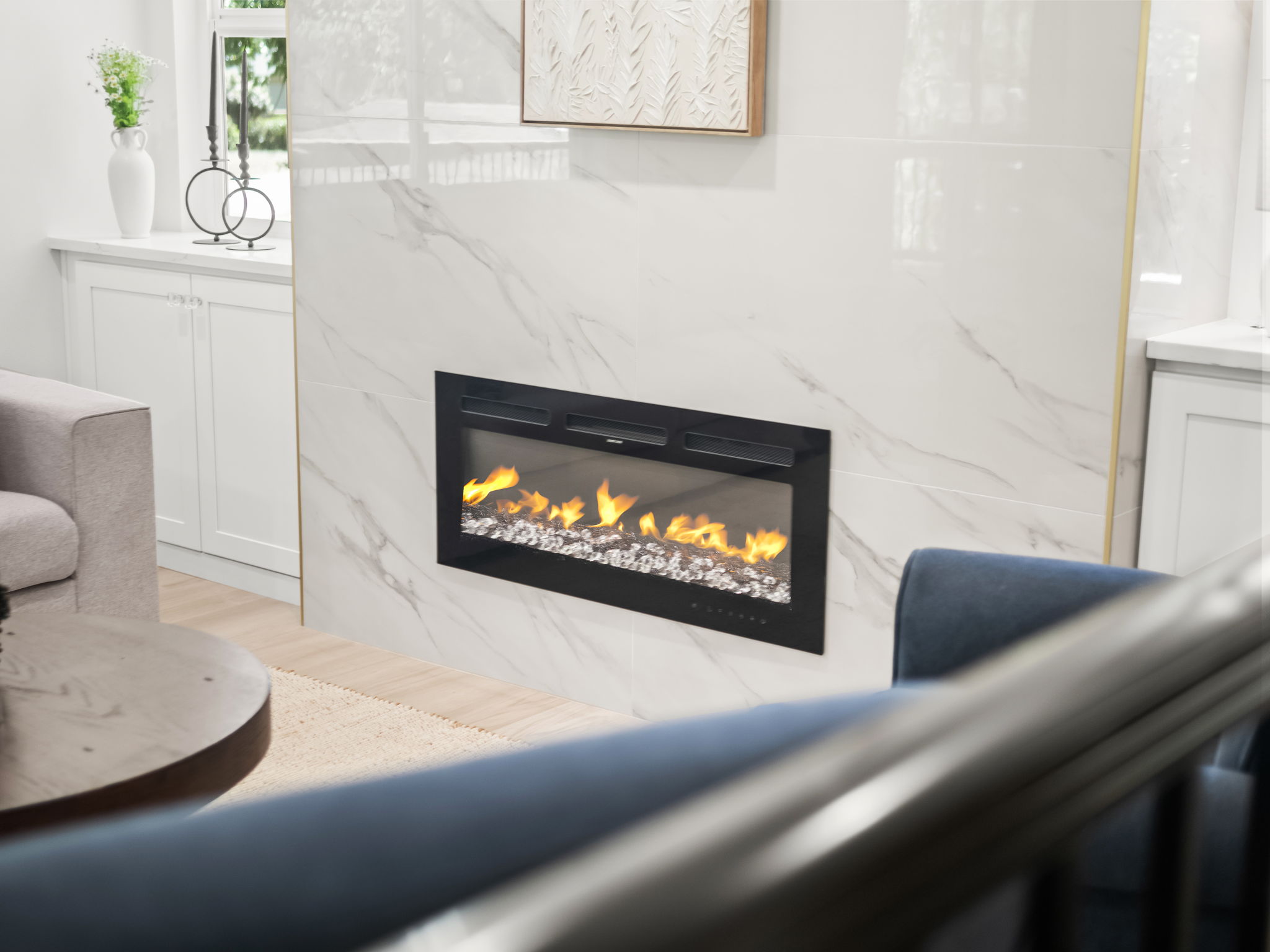 Linear electric fireplace set into a porcelain tile accent wall in the main floor living room