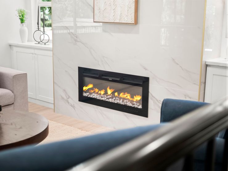 Linear electric fireplace set into a porcelain tile accent wall in the main floor living room